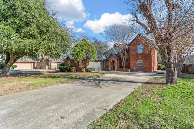 view of front of home featuring a garage and a front lawn