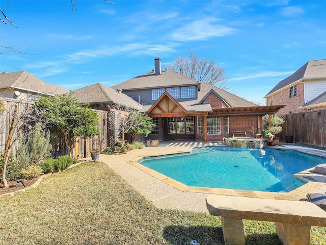 view of pool featuring a yard, a patio area, and an in ground hot tub