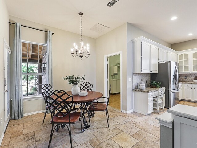 kitchen featuring appliances with stainless steel finishes, a breakfast bar, decorative backsplash, a kitchen island, and white cabinetry