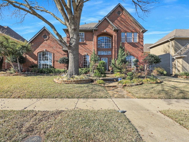 view of property featuring a front lawn