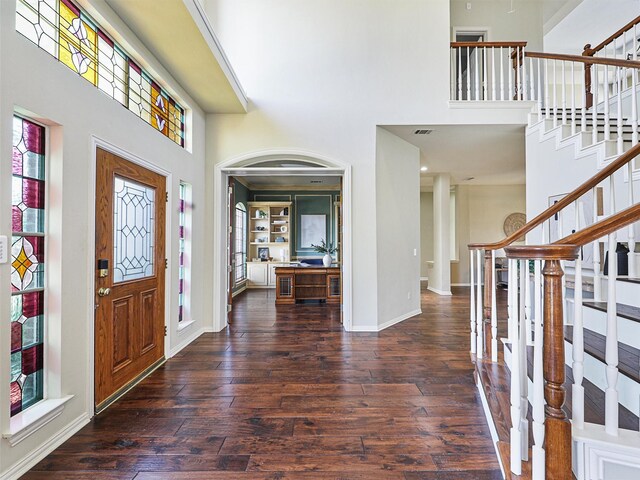 office with dark wood-type flooring and ornamental molding