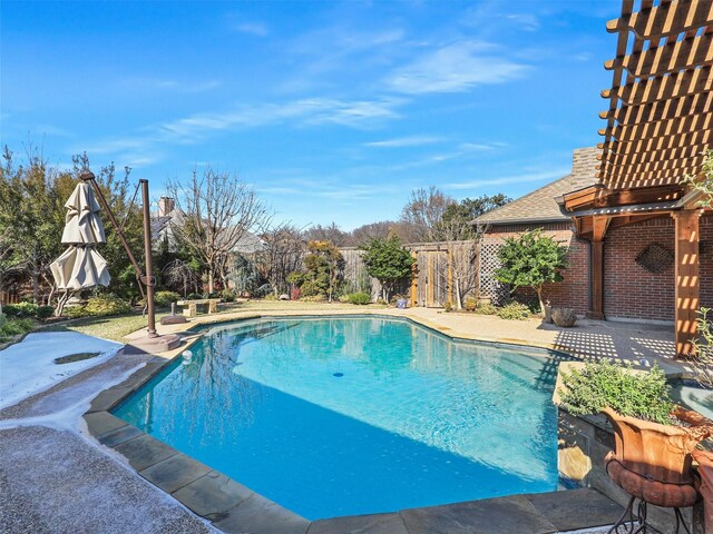 view of pool featuring a patio, a lawn, and an in ground hot tub