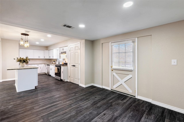 kitchen with a center island, decorative light fixtures, stainless steel appliances, backsplash, and white cabinets