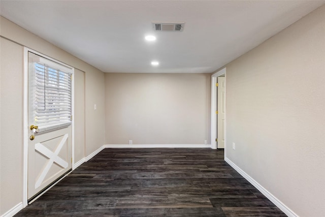 unfurnished room featuring dark hardwood / wood-style floors