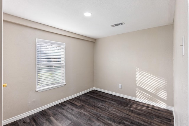 empty room with dark hardwood / wood-style floors