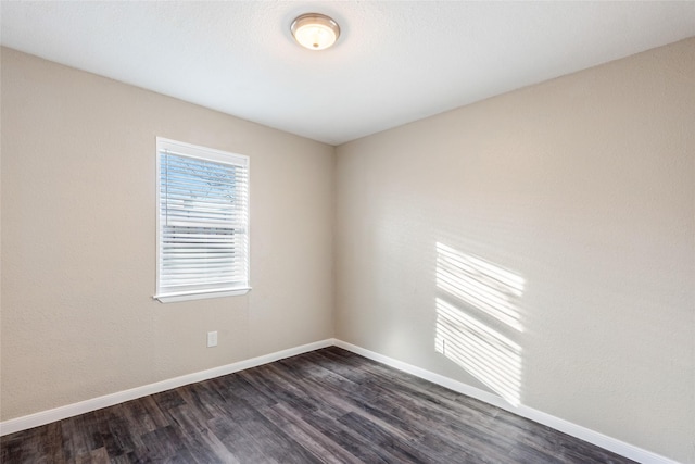 empty room with dark hardwood / wood-style floors