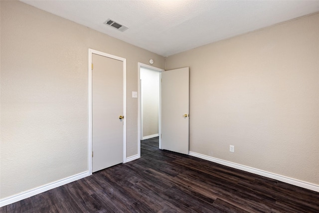 unfurnished room featuring dark hardwood / wood-style flooring