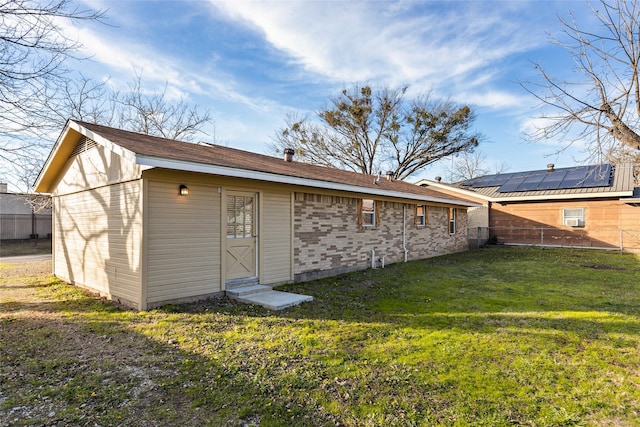 back of property featuring a yard