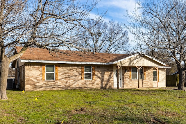 view of front of home featuring cooling unit and a front yard