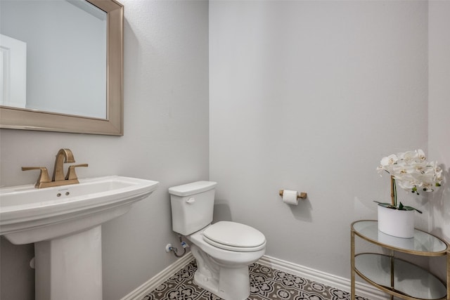 bathroom with tile patterned flooring and toilet