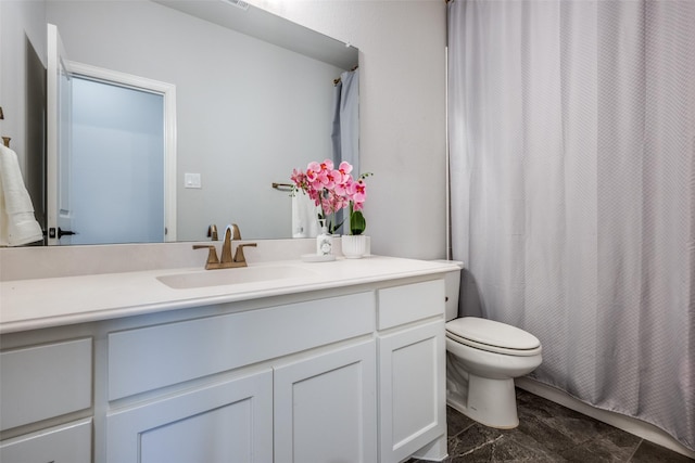 bathroom featuring toilet, vanity, and curtained shower