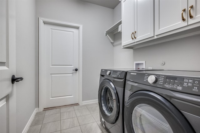 clothes washing area with independent washer and dryer, cabinets, and light tile patterned flooring