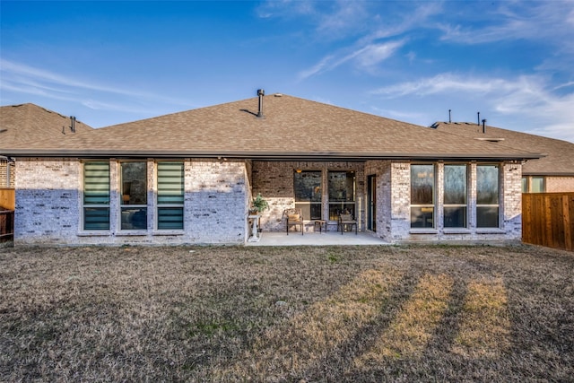 rear view of house featuring a lawn and a patio area