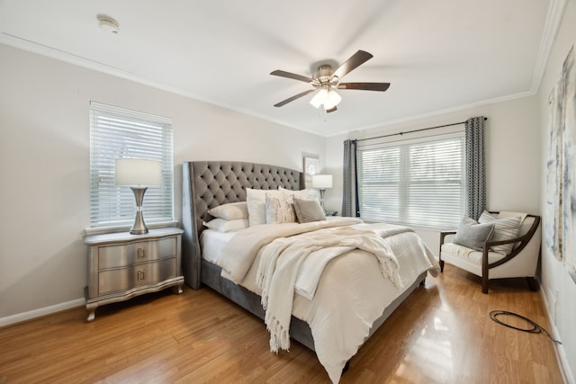 bedroom with ceiling fan, ornamental molding, and hardwood / wood-style flooring