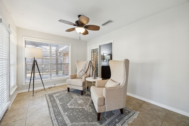 sitting room featuring tile patterned flooring and ceiling fan