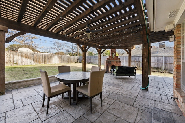 view of patio / terrace with an outdoor brick fireplace and a pergola