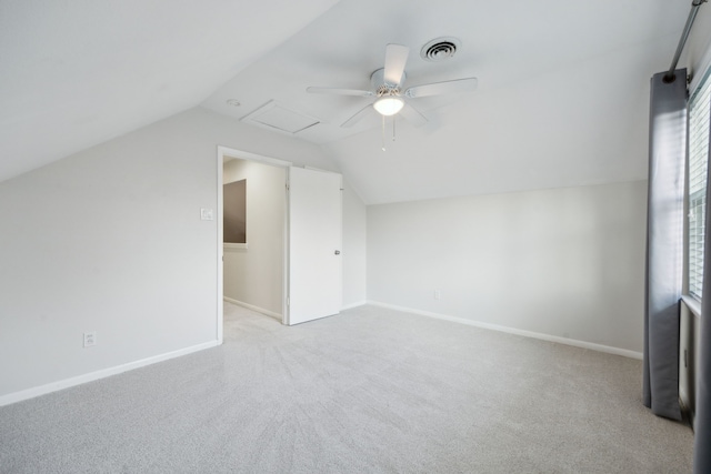 additional living space with lofted ceiling, light carpet, and ceiling fan