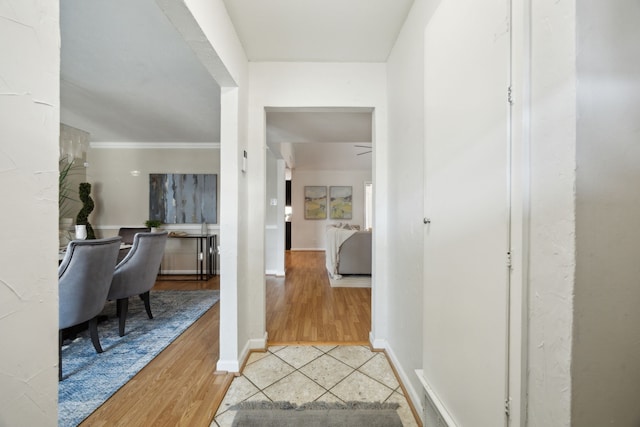 entryway with tile patterned flooring and crown molding