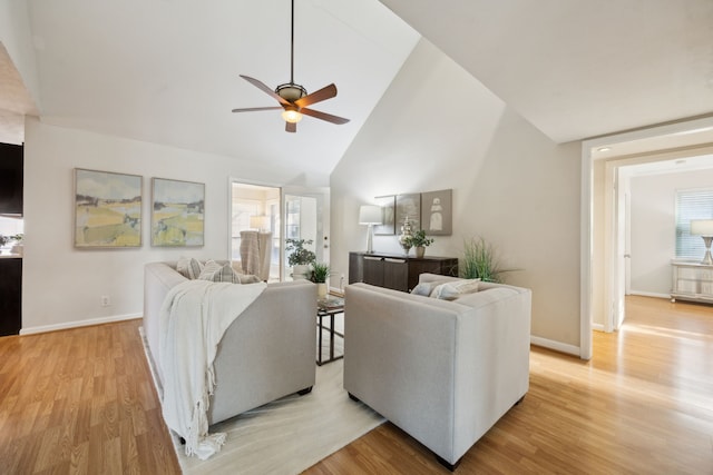 living room featuring high vaulted ceiling, ceiling fan, and light hardwood / wood-style flooring