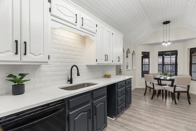 kitchen with decorative light fixtures, decorative backsplash, white cabinetry, black dishwasher, and sink