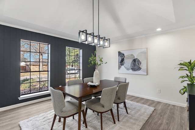 dining area featuring ornamental molding and wood-type flooring