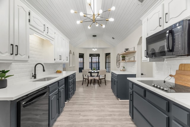 kitchen featuring black appliances, pendant lighting, and white cabinetry