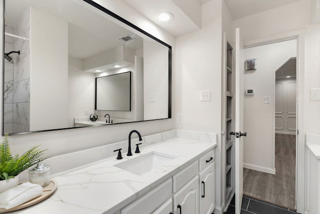 bathroom with hardwood / wood-style floors and vanity