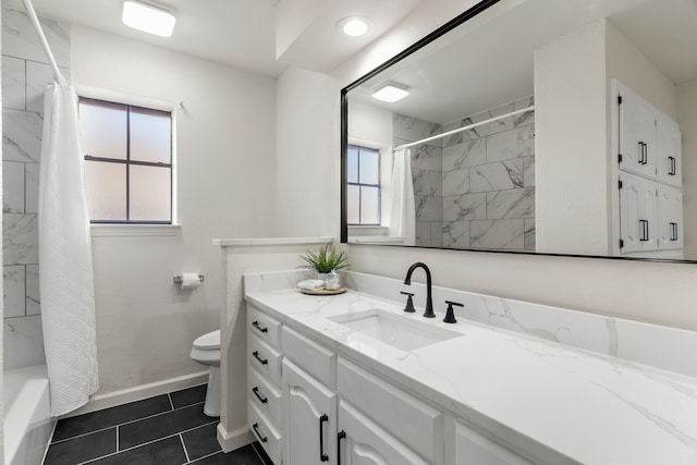 full bathroom with toilet, shower / bath combo with shower curtain, tile patterned floors, and vanity