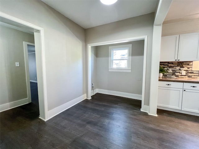 laundry room with dark wood-type flooring