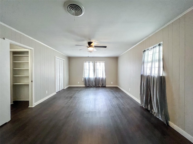 unfurnished room featuring ceiling fan, crown molding, and dark hardwood / wood-style floors