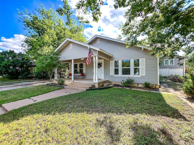 view of front of home with a front yard and a porch