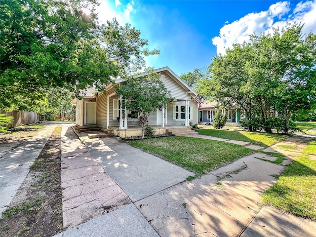 bungalow-style home featuring a front lawn