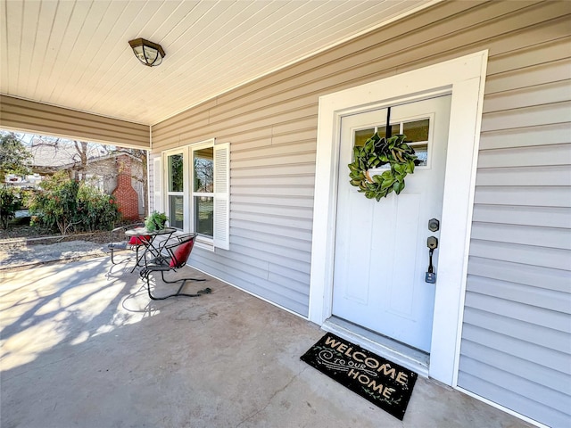 doorway to property featuring covered porch