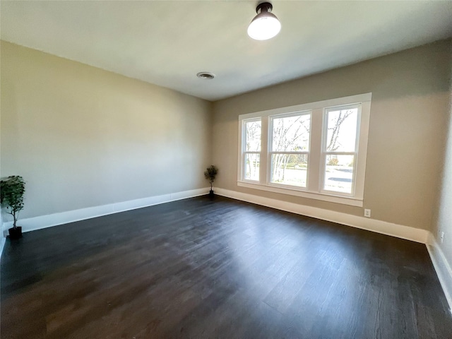 empty room with dark hardwood / wood-style floors