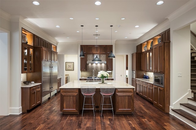 33 Glen Abbey Dr, Dallas, TX 75248 - kitchen with built in appliances, wall chimney exhaust hood, backsplash, glass insert cabinets, and recessed lighting
