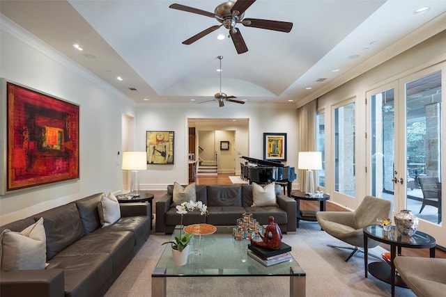 living room featuring a raised ceiling, french doors, crown molding, and a healthy amount of sunlight