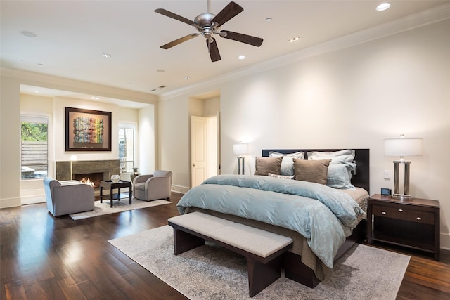 bedroom featuring dark hardwood / wood-style flooring, ceiling fan, and ornamental molding