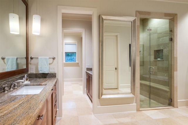 bathroom featuring ornamental molding, vanity, and a shower with shower door