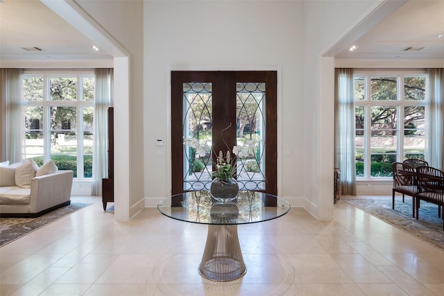 tiled entrance foyer with a healthy amount of sunlight