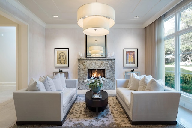 living area featuring tile patterned flooring, crown molding, and a fireplace