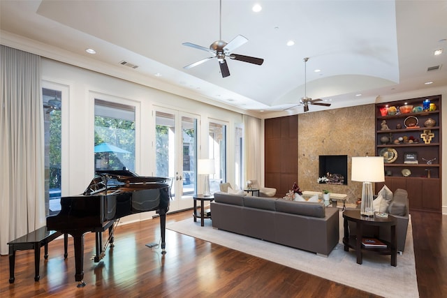 living room with ceiling fan, french doors, built in features, and lofted ceiling