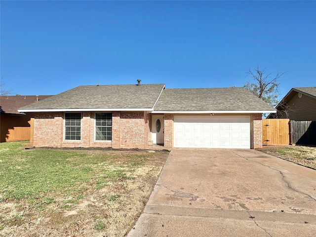 single story home featuring a garage and a front lawn