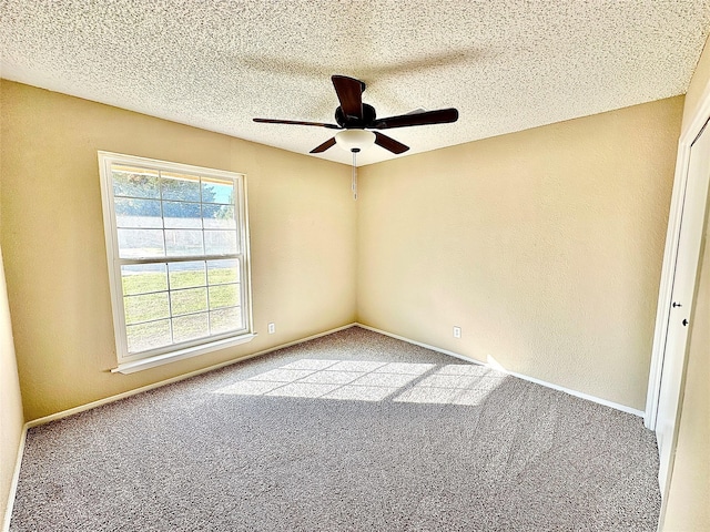 spare room featuring carpet floors, ceiling fan, and a textured ceiling