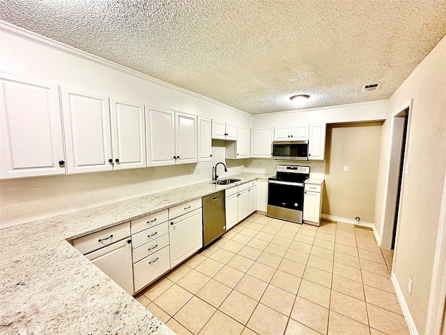 kitchen with sink, white cabinetry, light stone countertops, and appliances with stainless steel finishes