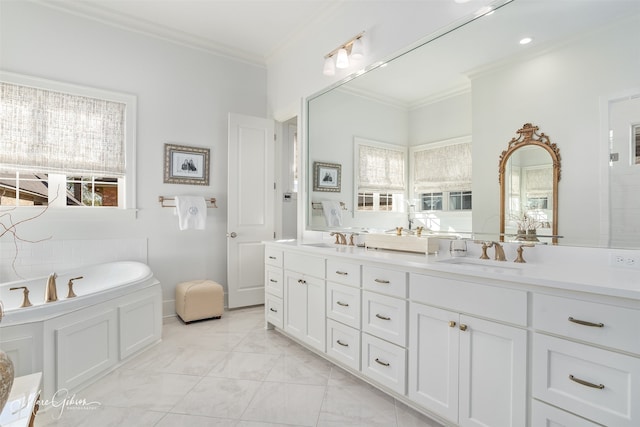 bathroom featuring a healthy amount of sunlight, a bathtub, ornamental molding, and vanity