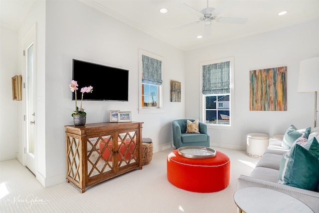 living room featuring ornamental molding, ceiling fan, and carpet flooring