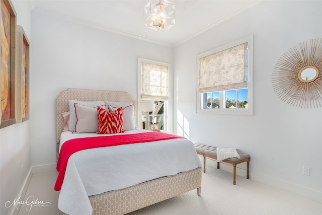 bedroom with ornamental molding and carpet flooring