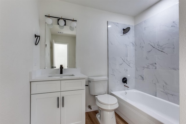 full bathroom with tub / shower combination, vanity, toilet, and wood finished floors