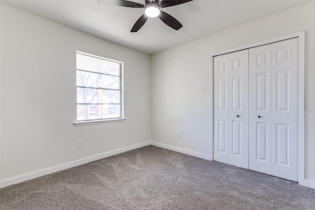 unfurnished bedroom featuring carpet floors, a closet, ceiling fan, and baseboards