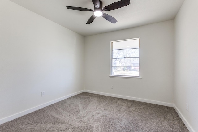 spare room featuring a ceiling fan, baseboards, and carpet flooring